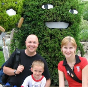 Jeffrey, Joshua and Mocha in front of a topiary face